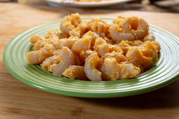 A view of a green plate of butternut squash mac n cheese.
