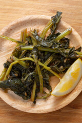 A top down view of a plate kohlrabi greens entree.