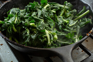 A view of a skillet of kohlrabi greens.
