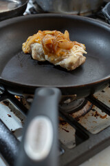 A view of a French onion chicken in a non-stick pan.