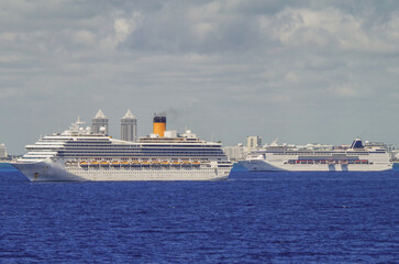 Modern cruiseships cruise ship liners Magica, Seaside, Armonia and Fortuna anchored offshore of...