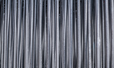 Close-up view of numerous vertically aligned, cylindrical metal pipes