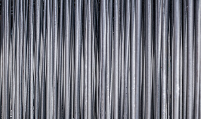 Close-up view of numerous vertically aligned, cylindrical metal pipes