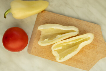 halved peppers with tomato on cutting board