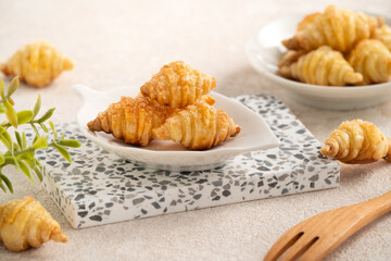 Mini Puff Pastry One Bite Croissants with Sugar on Ceramic Plate
