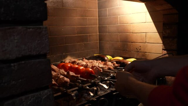 Meat on grill. Cooking shish kebab on skewers. Cooking pork meat on hot charcoal. Closeup of traditional picnic dish. Grilling meat on wood coal.