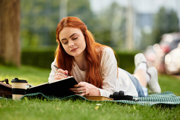 Relaxing afternoon with a notebook in a serene outdoor setting under a tree