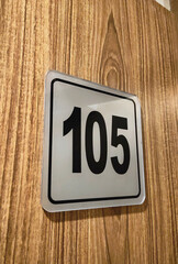Room Number 105 on Wooden Hotel Door