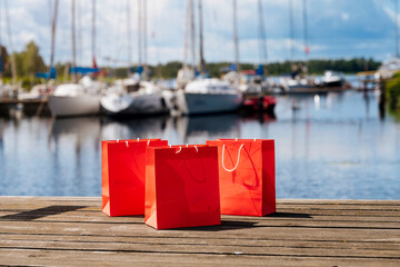 Red shopping bags during sunny day with blue sky background