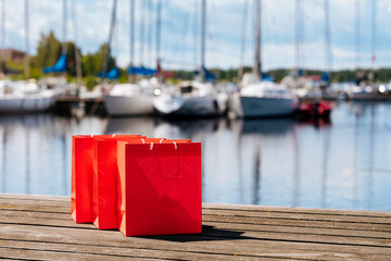 Red shopping bags during sunny day with blue sky background