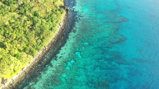 Top down aerial view over coral reefs at Hideaway beach on Tokoriki island Fiji.

