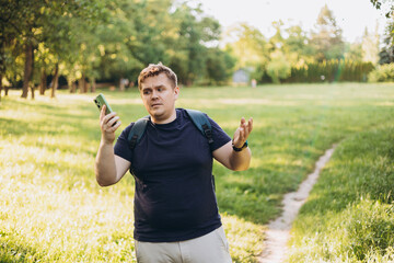 Sad blonde man got lost and could not find an internet connection on phone on the nature...
