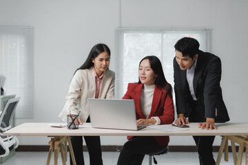 Three business professionals engage in a collaborative meeting, discussing strategies and ideas...