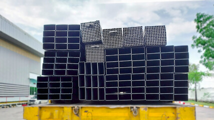 Rectangular hollow steel tubes stacked for industrial use, commonly applied in structural framing, fabrication, and modern construction projects.