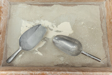White flour in a wooden box and metal scoops.Food concept