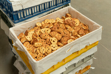 Many fresh sesame pretzels in pastry ready for packing