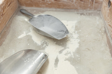 White flour in a wooden box and metal scoops.Food concept