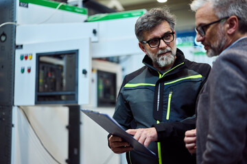 Professional Discussion Between Two Engineers in an Industrial Facility Setting