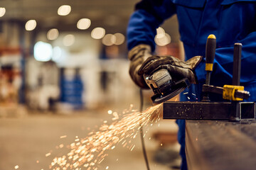 Worker Grinding Metal With Sparks in an Industrial Workshop Setting