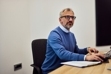 Professional Man Working at Computer in a Modern Office Environment