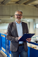 Confident Business Professional Conducting Workplace Evaluation Holding a Blue Clipboard