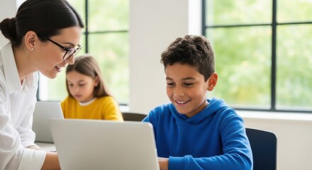 Teacher helps young student with computer learning