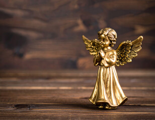 Golden praying christmas angel on wooden dark background für a card