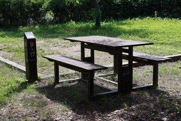 Wooden chairs and wooden tables in outdoor camping grounds