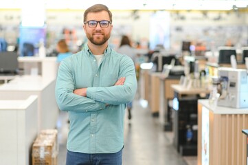 Happy man in electronics store. Big discounts