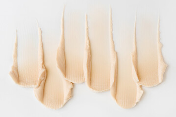 Smears of cosmetic cream on a white background