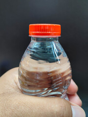 hand holding a mineral water bottle