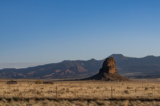 Indian Service Rte 13, The border between New Mexico and Arizona. In the distance is Roof Butte, a peak in the Chuska Mountains in Arizona.
