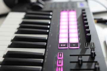 One portable MIDI keyboard on table, closeup