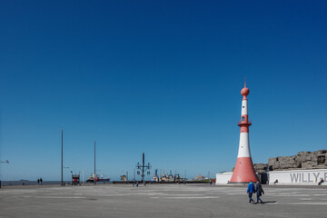 A wide shot of the historic Bremerhaven Lighthouse (Simon-Loschen-Leuchtturm) in Bremerhaven,...