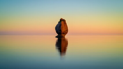 Beautiful sunset landscape with rock formation and water reflection nature scenery