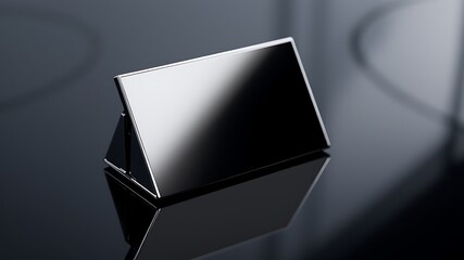 Sleek modern black nameplate with polished chrome edging resting on a reflective dark surface