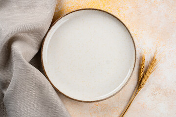 Empty Ceramic Plate on Rustic Stone Table. Minimalist Dining Concept
