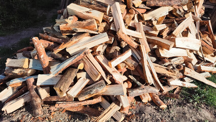 Heap firewood stack, natural wood. Cut firewood top view. Stock of firewood for heating house.