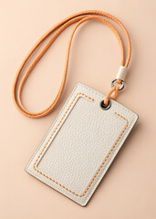 A closeup view of a beige leather id holder with a creamcolored background, hanging from a light brown cord, isolated on white background