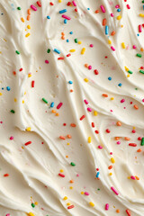 white buttercream frosting with colorful rainbow sprinkles, macro and full-frame texture shot, close-up texture, top view