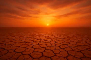 Poster Sunset over a cracked desert landscape