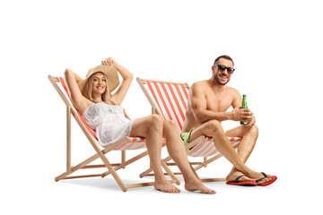 Young couple sunbathing in beach chairs