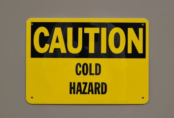 Caution Cold Hazard safety sign notice on wall industrial occupation.