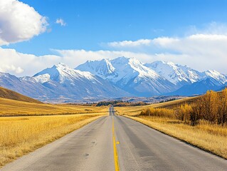 Naklejka premium Serene Mountain Road Under Blue Sky with Snow-Capped Peaks