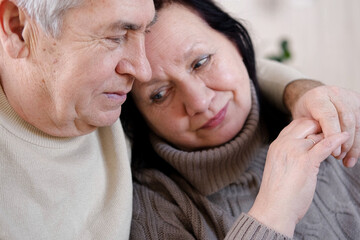 Senior couple hugging each other, kissing at home bedroom. Intimate Moment. Tender embrace between...