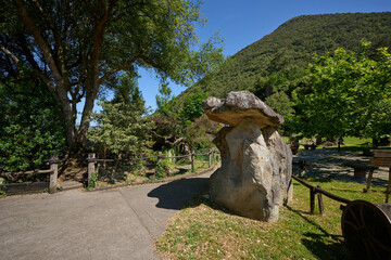Ancient rock formation in lush park setting
