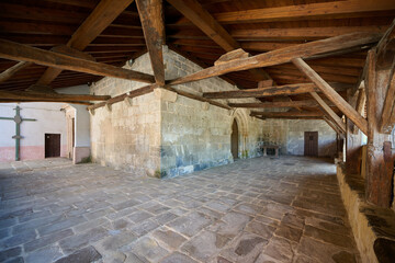 Historic stone courtyard with wooden roof beams
