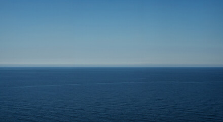 Fototapeta premium Serenity of the Deep Blue Ocean Under a Clear Sky