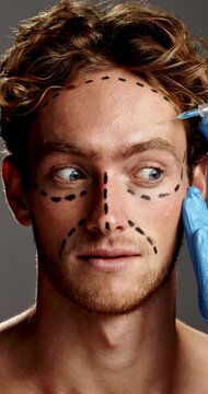 Plastic surgery, shock and face of man in studio for facial treatment, facelift and skincare. Dermatology, gray background and lines on person with injection for cosmetics, aesthetics and change