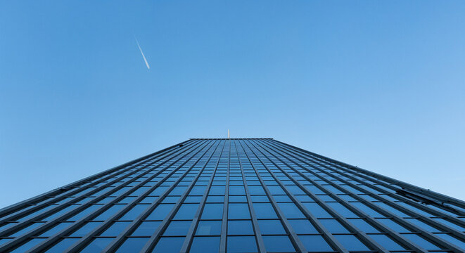 Skyscraper Reaching for a Clear Blue Sky - Powered by Adobe